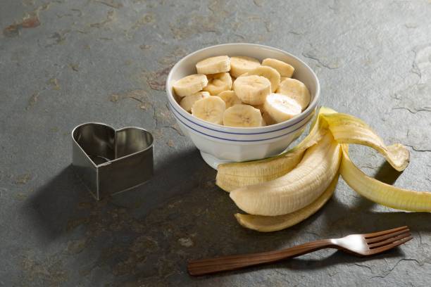 istock Banana slice on a bowl in a rustic stone table 1085018606