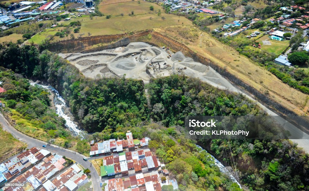 Ariel view, San Juan Costa Rica An Ariel view showed neighborhoods with scrap metal roofs, bordering a river and a mine site. Aerial View Stock Photo