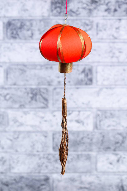 istock Red gold handmade diy chinese lanterns against a gray brick wall. Gift ideas, decor, concept for the Chinese New Year. Sky lantern 1085027092