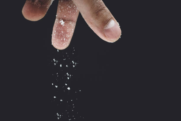istock seasoning salt cooking on black background 1085031852