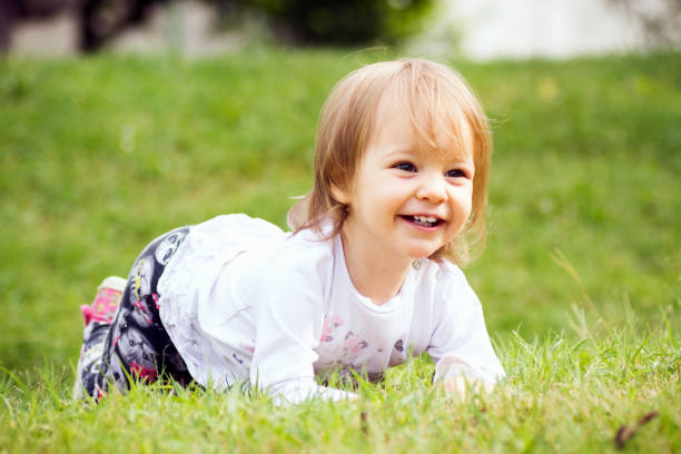 istock baby girl on grass 1085032404