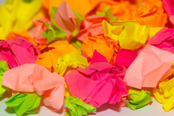 istock Bright crumpled multi-colored stickers on the office white board. 1085046844
