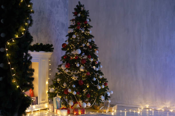 istock Christmas tree with presents, Garland lights new year 1085047570
