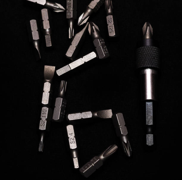 istock Tool carbon steel bits with bit holder on black background in dark key style. 1085047920
