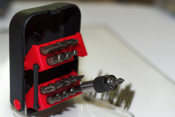 istock Bits holder in box and many tool bits on white background. Close-up view. Red element in plastic box. 1085047926
