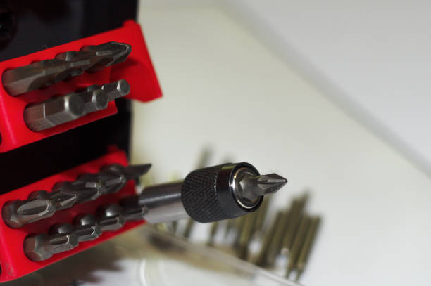 istock Bits holder in box and many tool bits on white background. Close-up view. Red element in plastic box. 1085047932