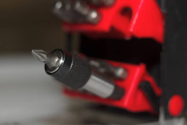 istock Bits holder in box and many tool bits on white background. Close-up view. Red element in plastic box. 1085047952