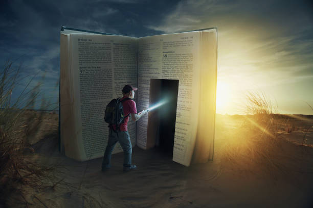 Door in Bible A man discovers a door inside a Bible. chasing photos stock pictures, royalty-free photos & images