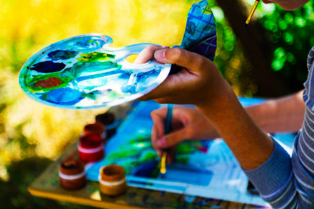 istock Young artist man drawing outdoors with palette in hand. 1085051922
