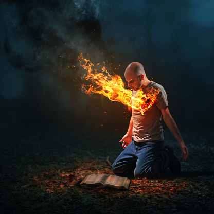 A man reads his Bible as his heart burns.