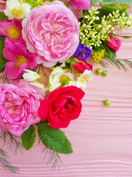 istock beautiful rose composition on a pink wooden background 1085052580