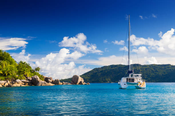Catamaran near shore of Seychelles Amazing tropical beach with granite boulders, Felicite, Seychelles la digue island photos stock pictures, royalty-free photos & images