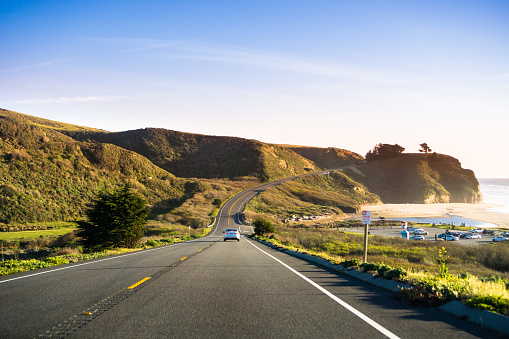 Driving on Highway 1 on the Pacific Ocean coastline close to Half Moon Bay, California