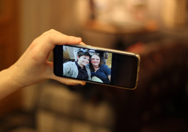 istock Two Friends Taking a Selfie in Bar With Smartphone. 1085056952