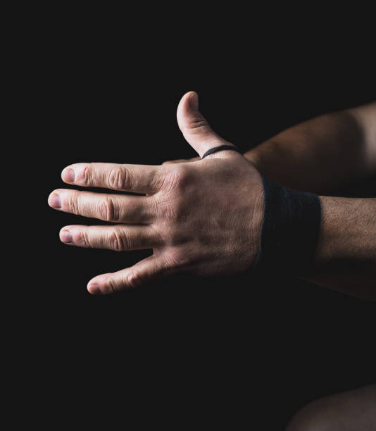 istock man wraps his hands in black textile bandage 1085060590
