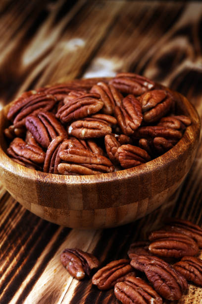 istock Pecan nuts on a table and pecan nuts in bowl 1085061822
