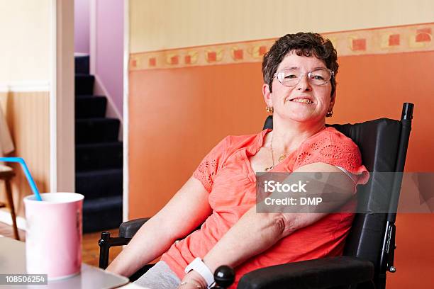 Disabled Woman In Wheelchair Enjoying Hot Drink At Home Stock Photo - Download Image Now