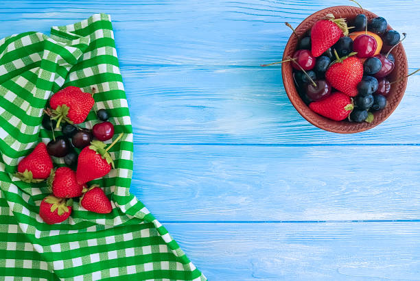 istock strawberries, blueberries on a blue wooden background 1085069228