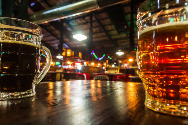 istock Two glass mugs with light and dark beer are in the table 1085069544