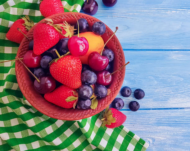 istock strawberries, blueberries on a blue wooden background 1085069988