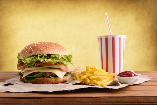istock Beef burger with soda chips and souces on table golden 1085071842