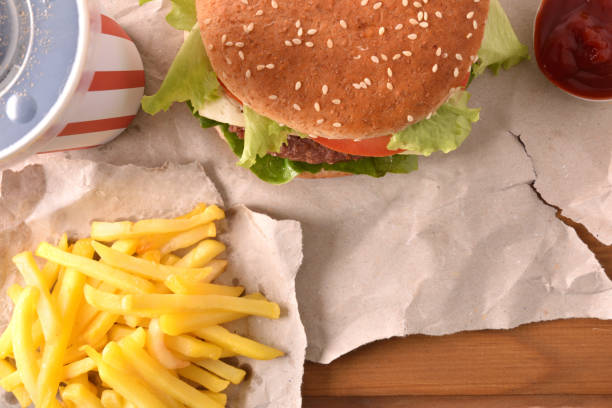 istock Burger with soda and chips with on table top view 1085071882