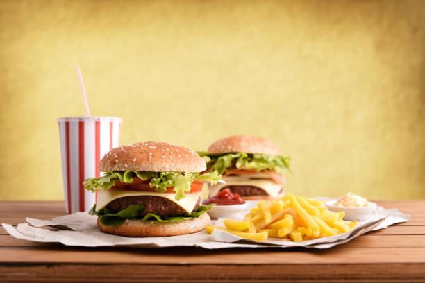 istock Two burger with soda and chips with souces on table 1085071902