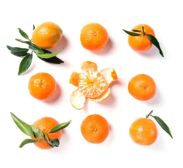 Ripe orange mandarine, tangerine, clementine with leaves isolated on white background, fruits top view