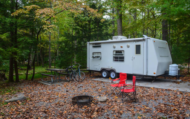 Camp trailer set up in campground site with bicycles stock photo