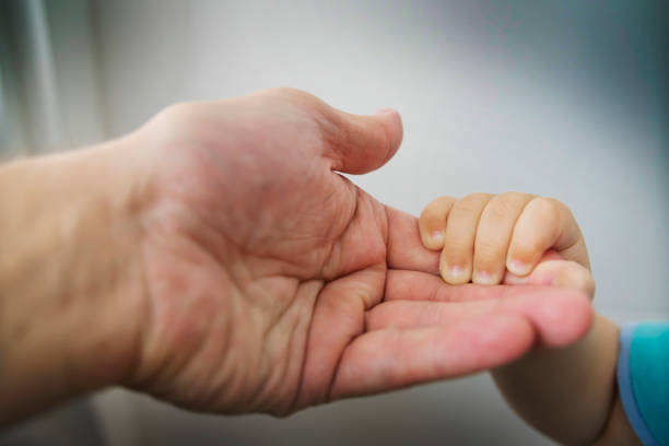 istock the child's hand in the parent's hand 1085077036