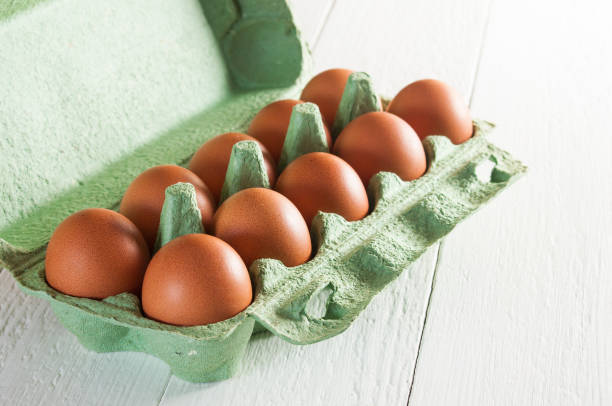 istock Ten brown chicken eggs in carton box. 1085080128