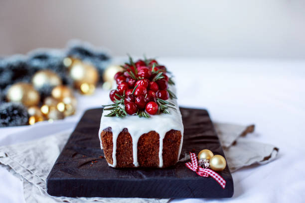 istock Christmas pudding with red berries and icing with christmas decoration on white background. Vintage style. 1085083748