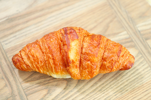 freshly baked croissants on wooden cutting board, top view - Image