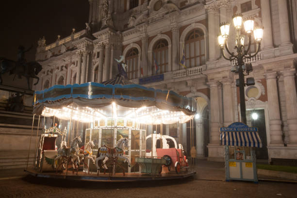Antique carousel illuminated at night next to Palazzo Carignano, Turin, January 2013