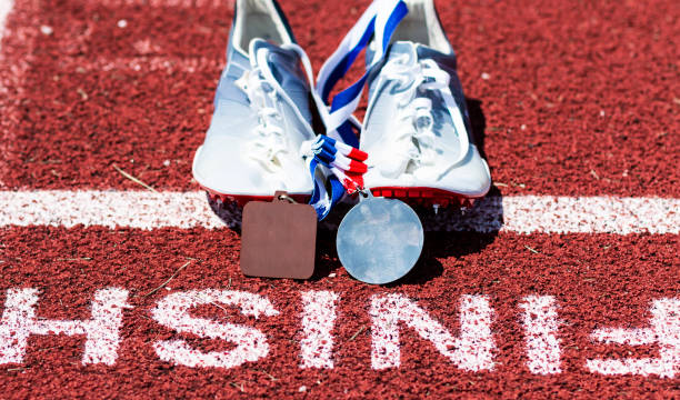 istock Running spikes at the finish line with medals 1085094944