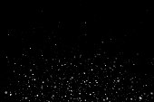 White sparkles on black background