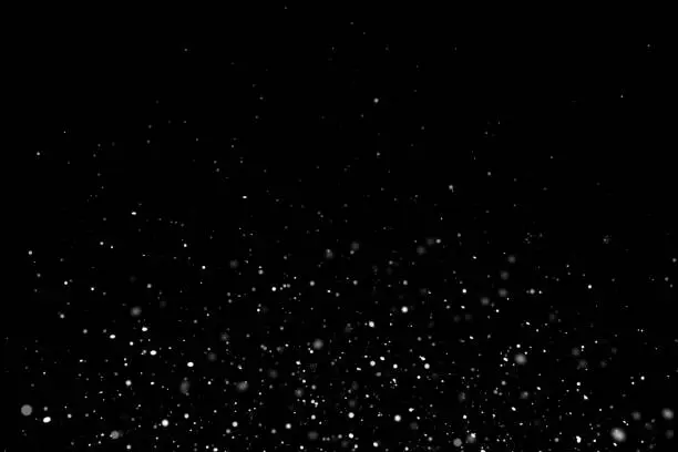 Photo of White sparkles on black background
