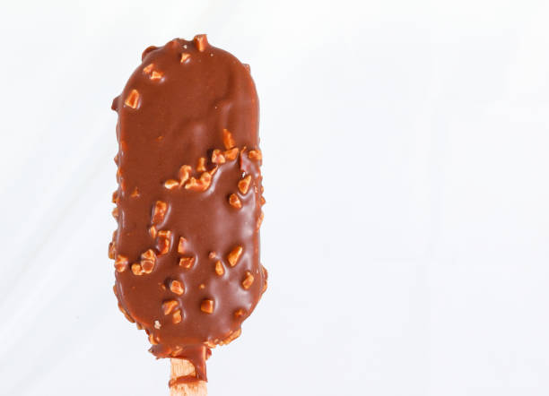 istock Almond popsicles on an iced tray with a pitcher of melted chocolate 1085099482