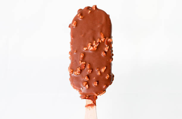 istock Almond popsicles on an iced tray with a pitcher of melted chocolate 1085099486