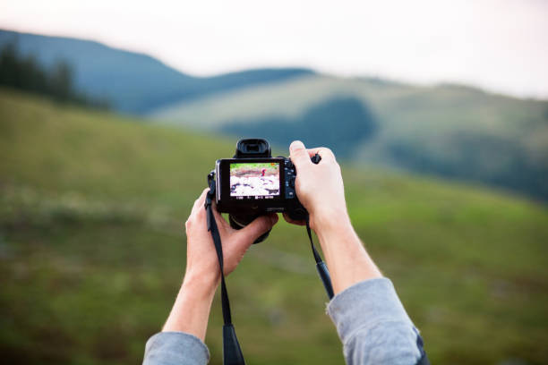 istock Hands holding the digital photo camera 1085099544
