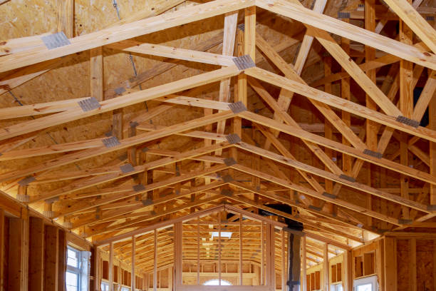 Close-up new stick built home under construction under blue sky Framing structure wood frame of wooden houses home.