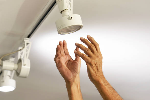 istock Electrician male man worker installing a ceiling LED spotlight 1085106032