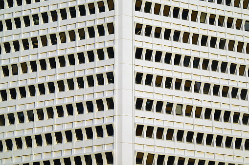 Angle modern business building skyscraper. Repeating patterns, architectural details and geometric constructions. Residential buildings. Pattern of windows and room in building