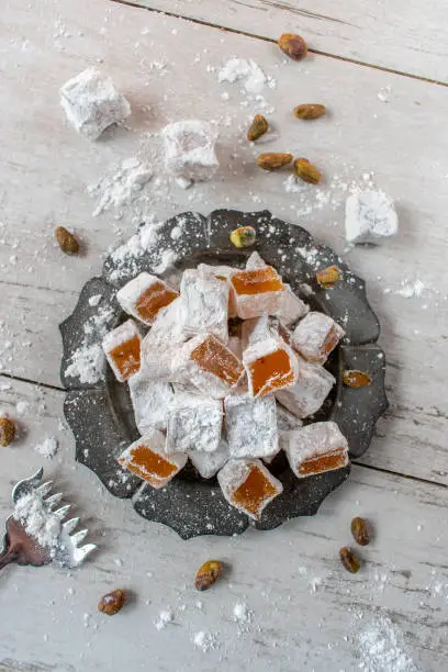 Turkish Delight candy on rustic plate flat lay