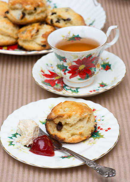istock Scones with clotted cream and jam on Christmat Poinsettia pattern antique English tableware, in Canada 1085120964
