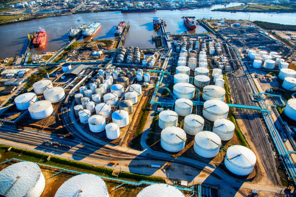 Aerial View of a Texas Oil Refinery and Fuel Storage Tanks A group of large sea baring oil tankers moored at a Texas oil refinery near Trinity Bay just outside of Houston, Texas, loading oil for export throughout the world. refinery photos stock pictures, royalty-free photos & images