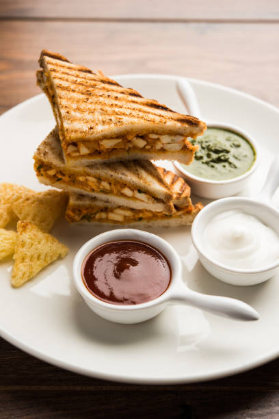 istock Paneer tikka Sandwich - is a popular Indian version of sandwich using cottage cheese curry with tomato ketchup, mint chutney 1085140634