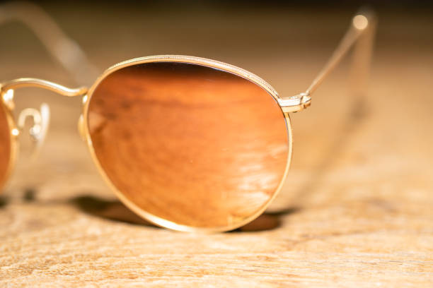 istock Orange Sunglasses closeup on wooden table 1085141290