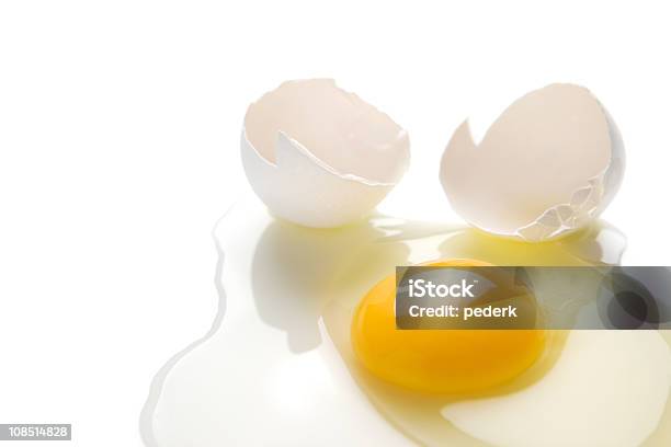 A Cracked Egg Spilt On A White Background Stock Photo - Download Image Now - Animal Egg, Broken, Color Image