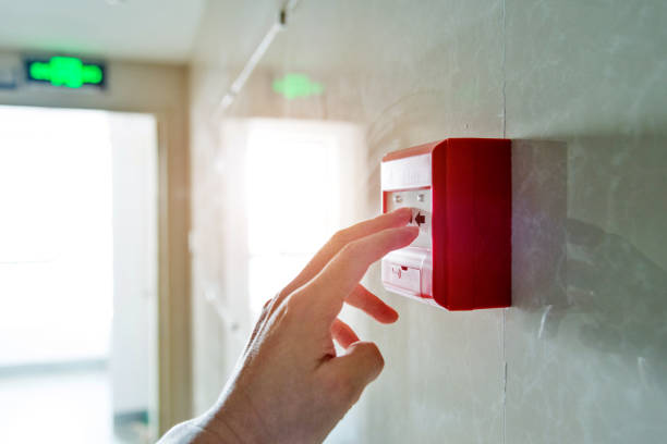 Human finger pushing fire alarm Human finger pushing fire alarm. school alarm stock pictures, royalty-free photos & images